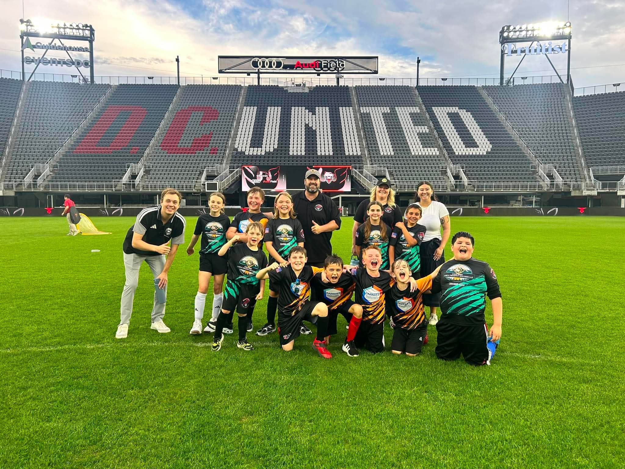 Raptors players together on the field at Audi Field.